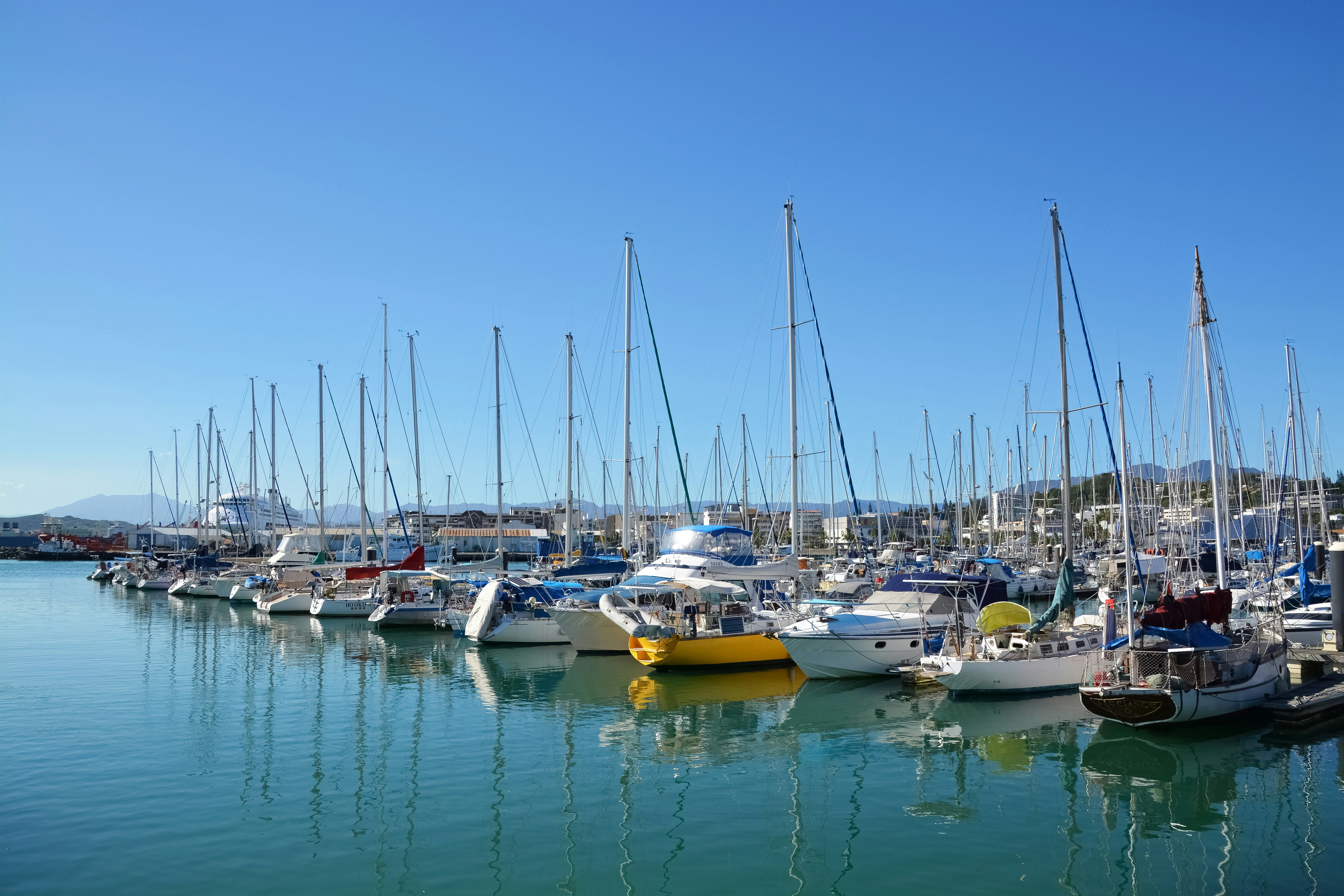 white and yellow boats on sea during daytime